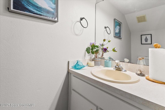 bathroom featuring vanity and vaulted ceiling