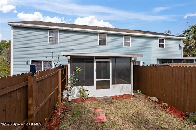 rear view of property with a sunroom