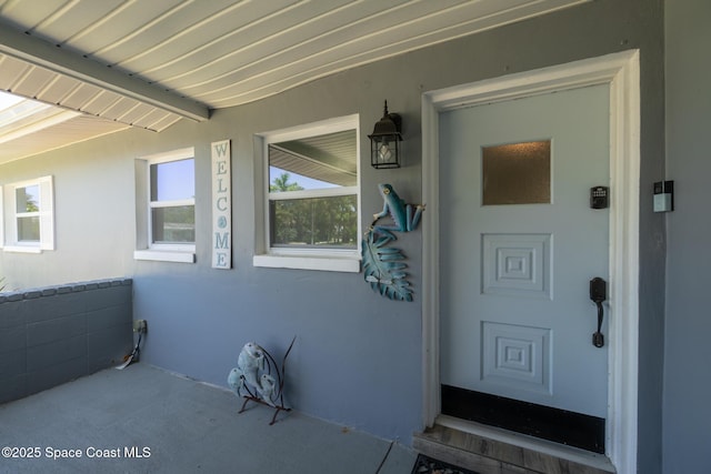 346 Cyprus Dr, Cocoa Beach, FL 32931 - doorway to property featuring stucco siding