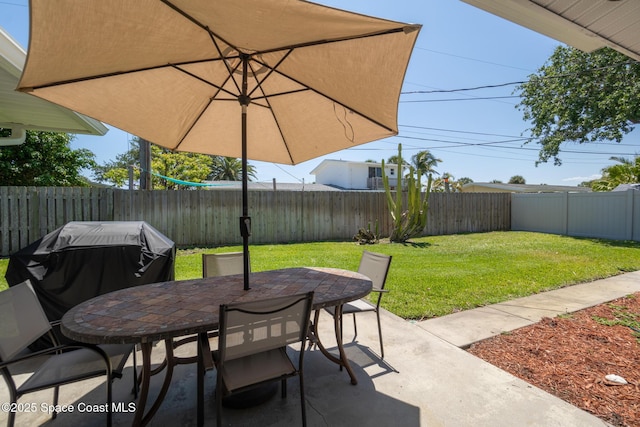346 Cyprus Dr, Cocoa Beach, FL 32931 - fenced backyard featuring outdoor dining area, a patio, and area for grilling