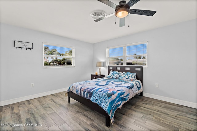 346 Cyprus Dr, Cocoa Beach, FL 32931 - bedroom featuring multiple windows, wood finished floors, and ceiling fan