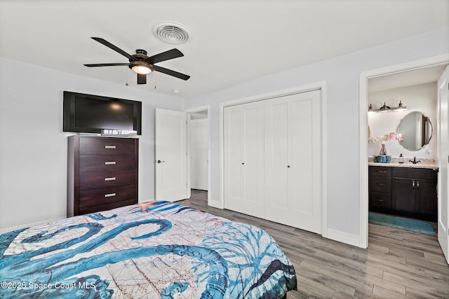 346 Cyprus Dr, Cocoa Beach, FL 32931 - bedroom featuring wood finished floors, a closet, a ceiling fan, and connected bathroom