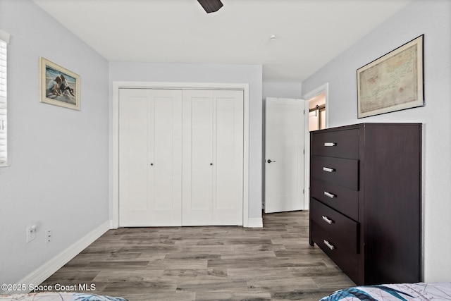 346 Cyprus Dr, Cocoa Beach, FL 32931 - unfurnished bedroom featuring a closet, wood finished floors, and a ceiling fan