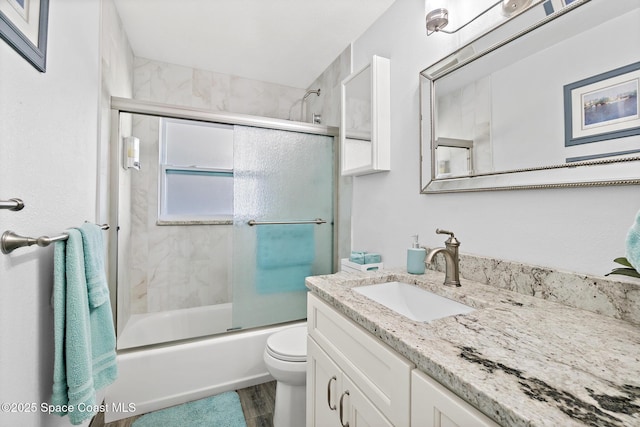 346 Cyprus Dr, Cocoa Beach, FL 32931 - bathroom featuring vanity, combined bath / shower with glass door, and wood finished floors