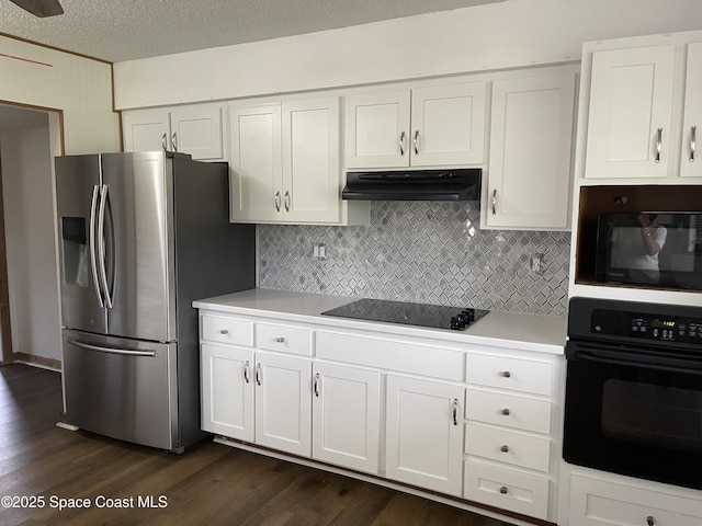 kitchen featuring dark wood-type flooring, white cabinets, black appliances, and a textured ceiling