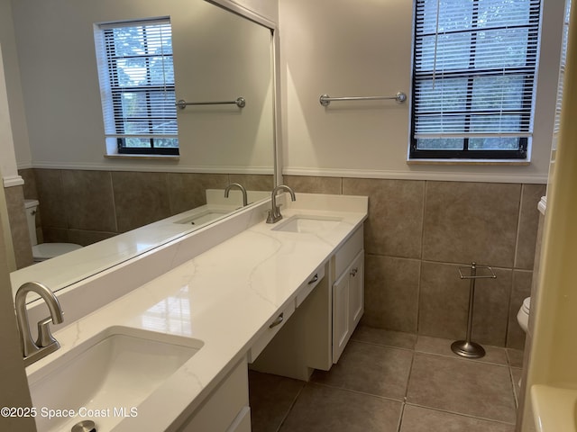 bathroom featuring tile patterned flooring, vanity, and toilet