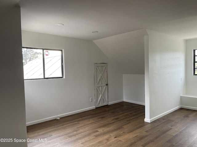 bonus room featuring dark hardwood / wood-style floors and vaulted ceiling