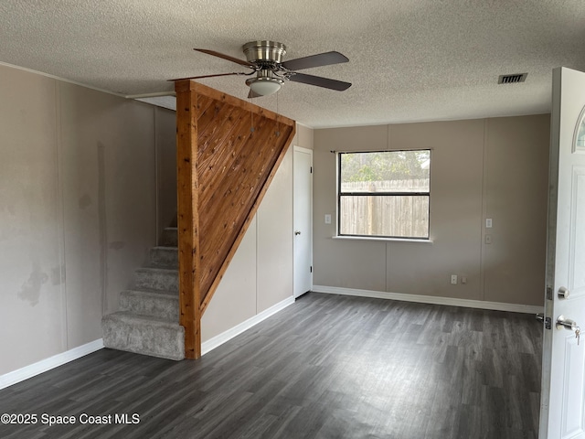 unfurnished room featuring a textured ceiling, dark hardwood / wood-style floors, and ceiling fan