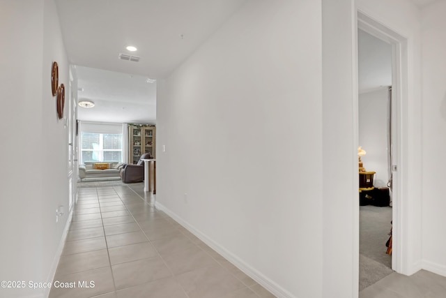 hall with light tile patterned floors