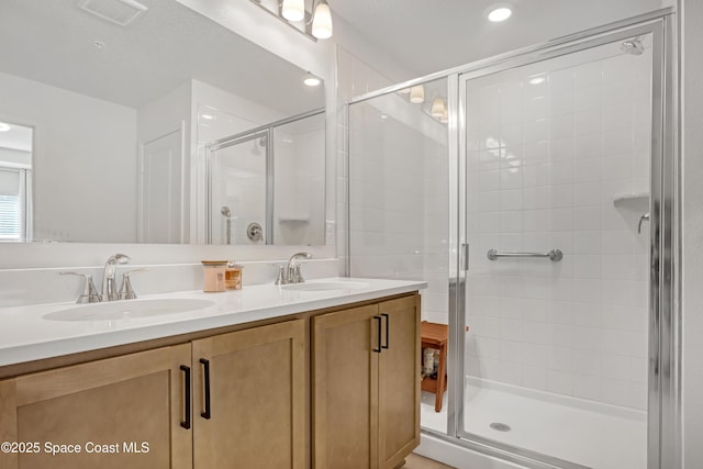 bathroom featuring vanity and a shower with door