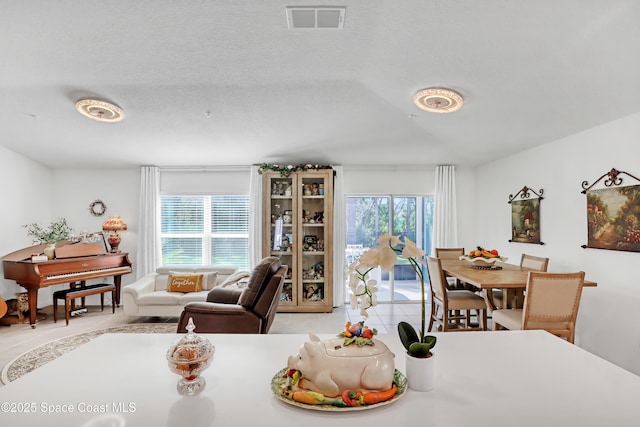 dining space with a textured ceiling