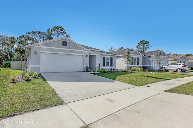 single story home featuring a garage and a front lawn