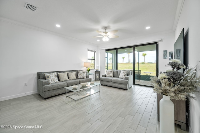 living room featuring ceiling fan and crown molding