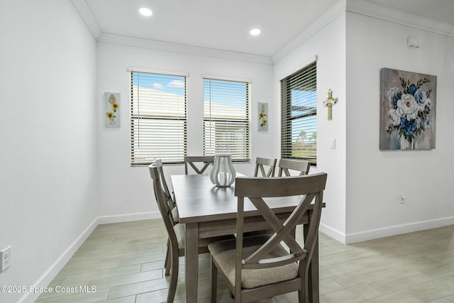 dining area featuring light wood-type flooring and ornamental molding