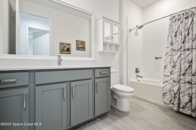 full bathroom with vanity, toilet, and shower / bath combo with shower curtain