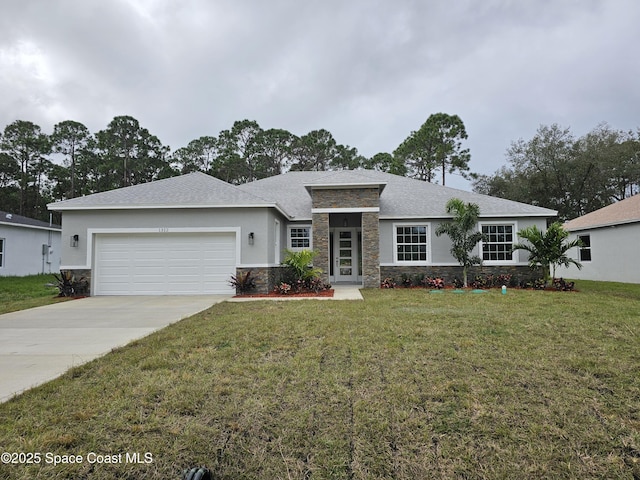 view of front of home with a front lawn and a garage