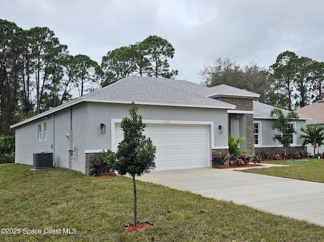 view of front of house featuring a garage, central air condition unit, and a front lawn