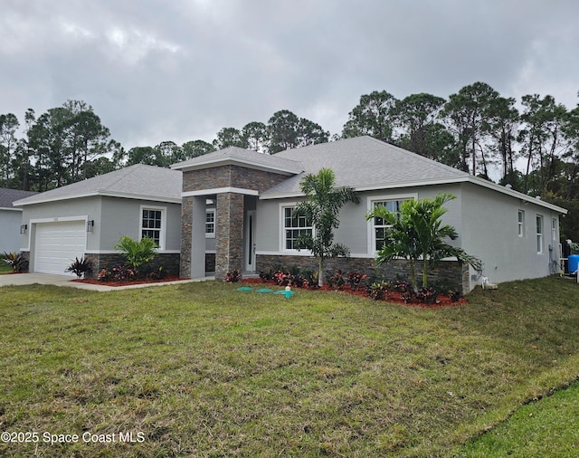 view of front of home with a front yard and a garage