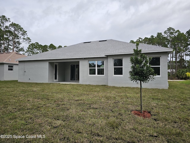 back of property with a patio and a lawn