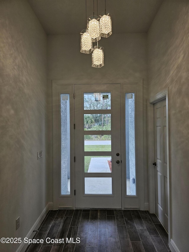 foyer entrance with a notable chandelier