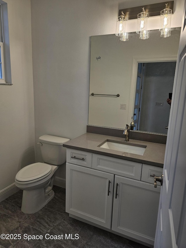 bathroom featuring toilet and vanity