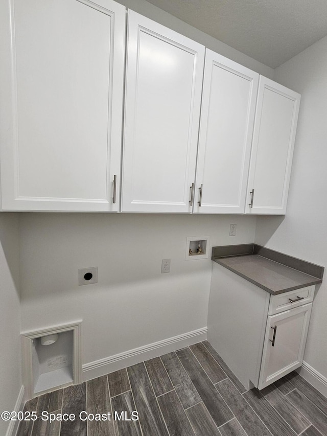 clothes washing area with cabinets, washer hookup, and electric dryer hookup