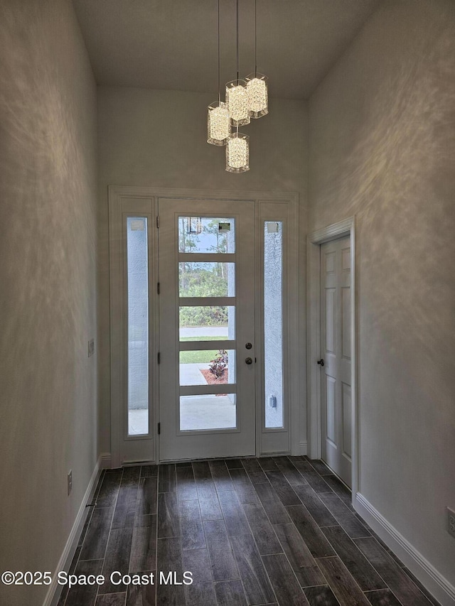 foyer featuring a chandelier and dark hardwood / wood-style floors