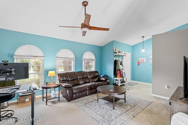 living room featuring ceiling fan, light colored carpet, and lofted ceiling