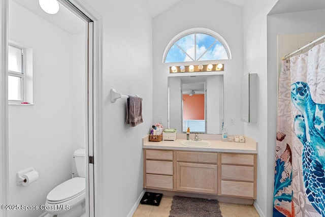 bathroom with tile patterned floors, vanity, toilet, and walk in shower