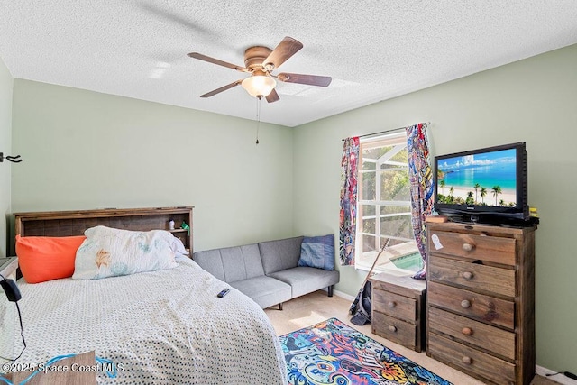 carpeted bedroom featuring ceiling fan and a textured ceiling