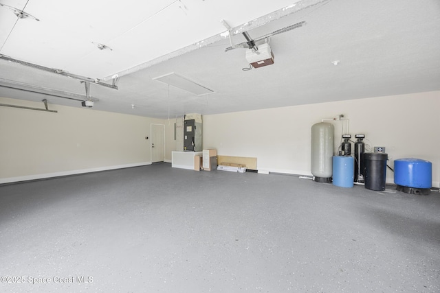 garage featuring a garage door opener and heating unit