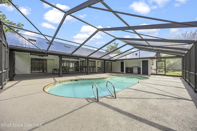 view of pool with ceiling fan, a patio, and glass enclosure