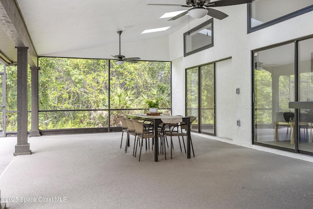 sunroom with ceiling fan, a healthy amount of sunlight, and decorative columns