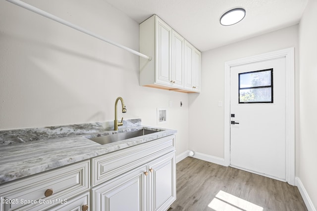 washroom featuring cabinets, hookup for a washing machine, light wood-type flooring, electric dryer hookup, and sink