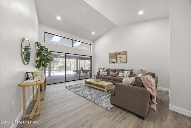 living room with high vaulted ceiling and hardwood / wood-style flooring