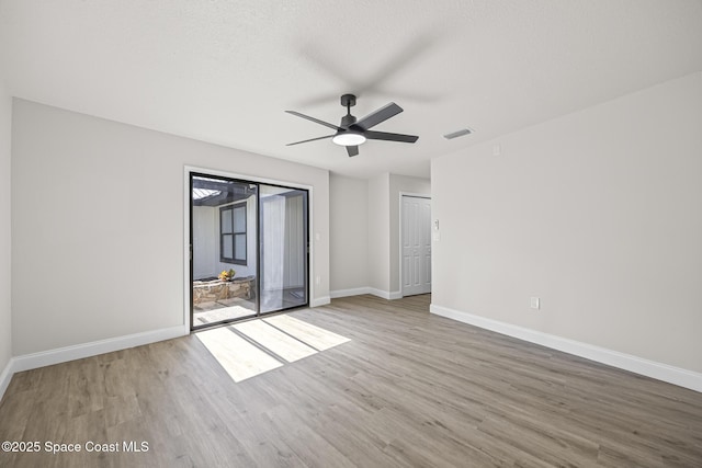 unfurnished bedroom featuring ceiling fan, light hardwood / wood-style floors, a textured ceiling, access to outside, and a closet