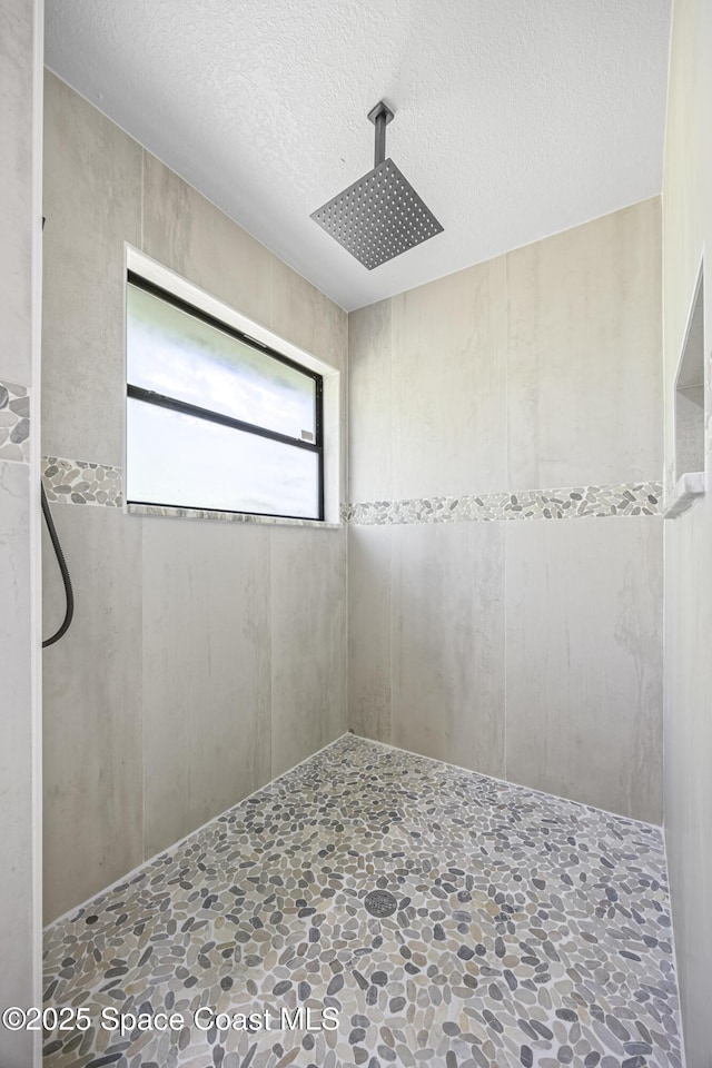 unfurnished room featuring a textured ceiling