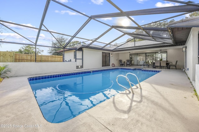 view of swimming pool featuring a patio area and a lanai