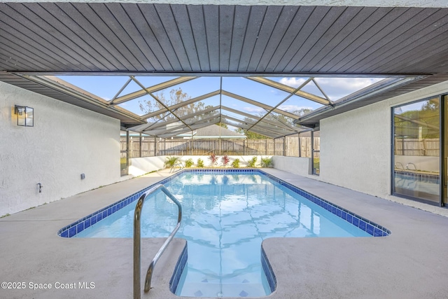 view of swimming pool featuring glass enclosure and a patio