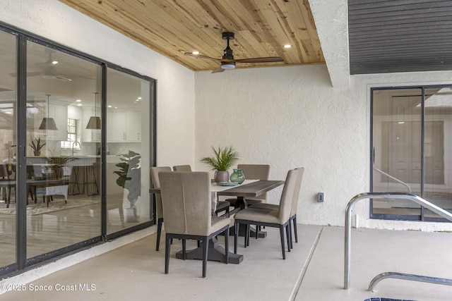 view of patio with ceiling fan and sink