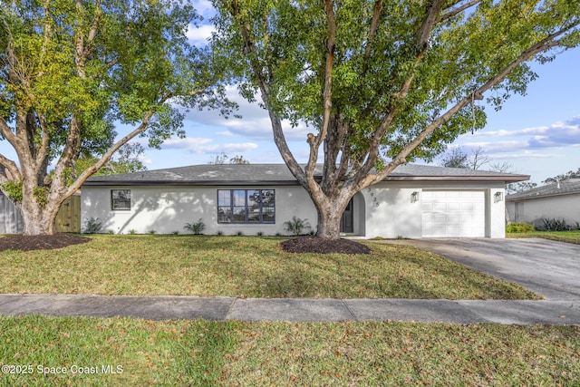 ranch-style house featuring a garage and a front yard