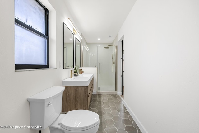 bathroom featuring tile patterned flooring, a shower with door, vanity, and toilet