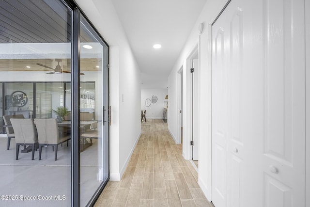 hallway with light hardwood / wood-style floors