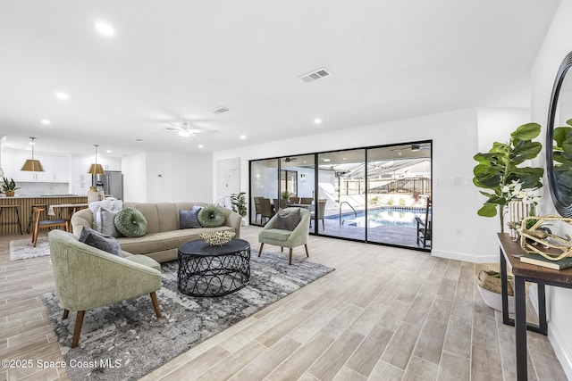 living room with light wood-type flooring and ceiling fan