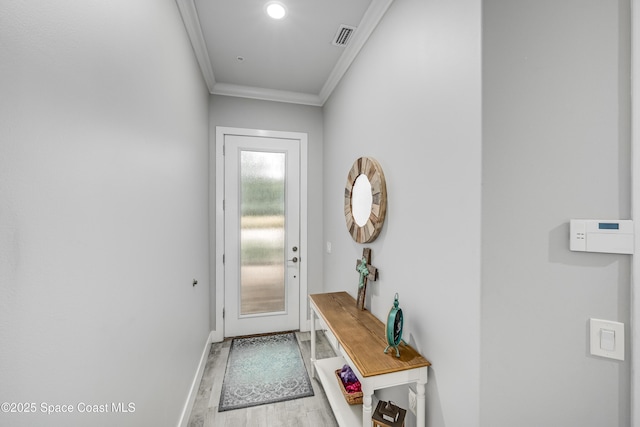 entryway with crown molding and light wood-type flooring