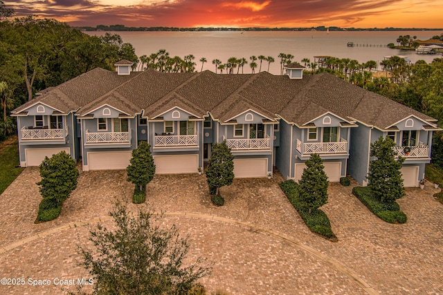 view of front facade featuring a water view and a garage