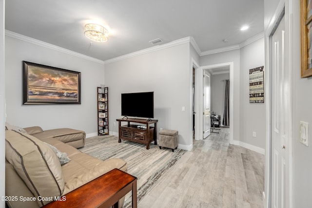 living room with light wood-type flooring and crown molding