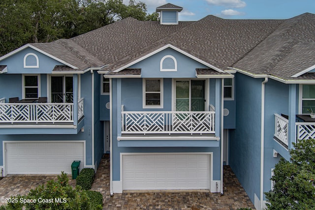 view of front of home with a balcony and a garage