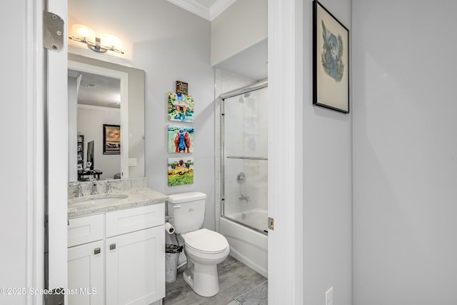 full bathroom featuring hardwood / wood-style flooring, vanity, toilet, and crown molding