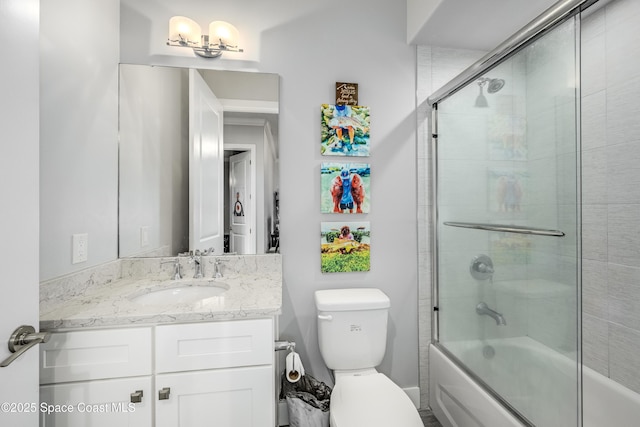 full bathroom with shower / bath combination with glass door, vanity, and toilet